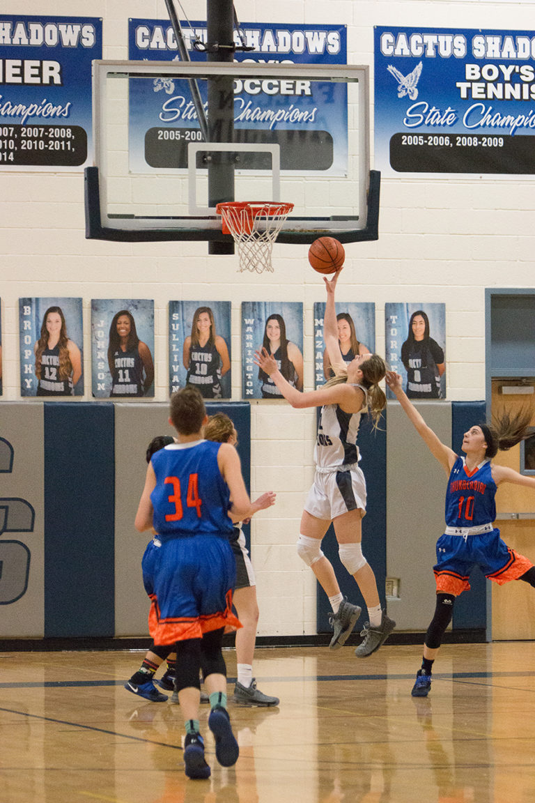 Caitlin Bickle shooting a basket